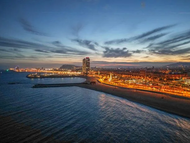 Barcelona coastline at night, city lights glowing