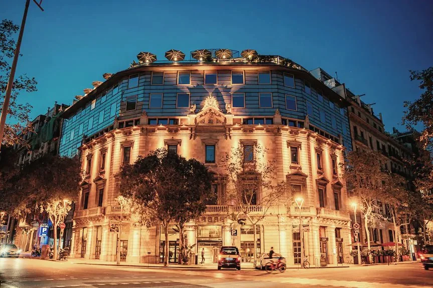 Claris Hotel & Spa, Barcelona — warm stone facade lit at night